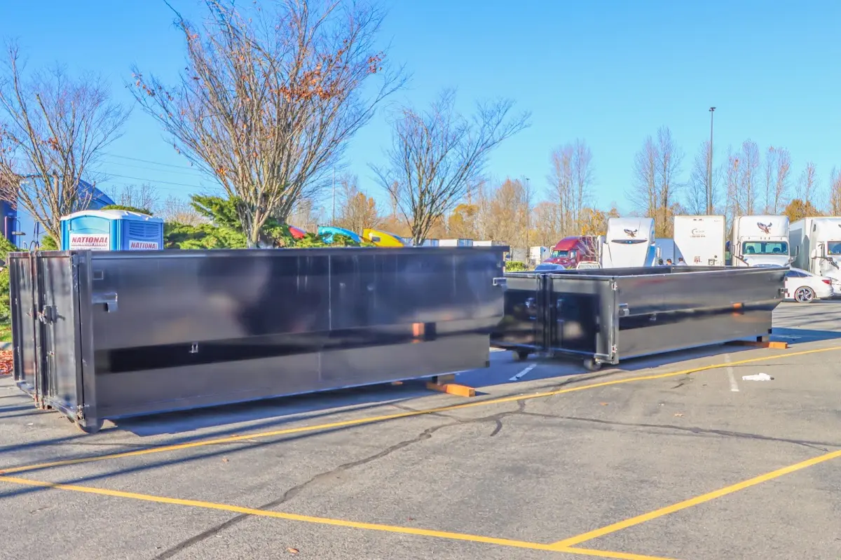 Professional dumpster rental service with roll-off container on residential driveway in Braselton